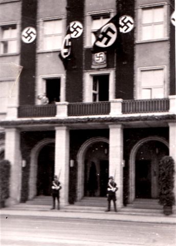 Hitler appears on balcony.
