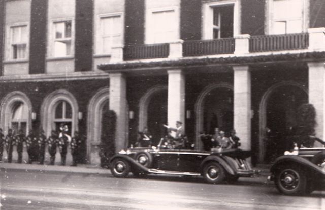 Hitler leaving the hotel with honor guard and drummer standing at left