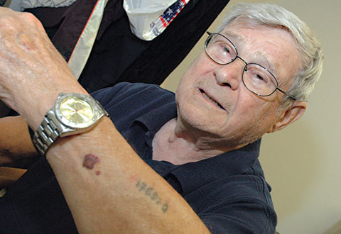 Paul Argiewicz proudly shows off his Auschwitz tattoo