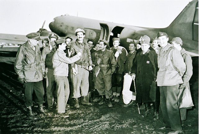 George Kraigher (far left) pilot of a DC 4 ferrying and picking up parachuted&nbsp; bomber crews at the airstrip near Drvar.
