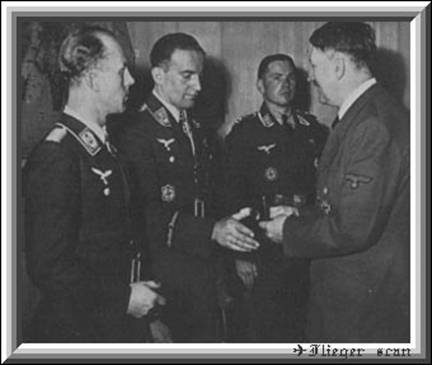 Rudel receives the Swords for his Knight's Cross with Oak Leaves from the hand of Adolf Hitler.
