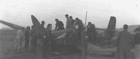 Oberst Hans-Ulrich Rudel's last aircraft, crashed and surrounded by Americans at Kitzingen, 8 May 1945. Rudel can be seen on the starboard wing of his aircraft.