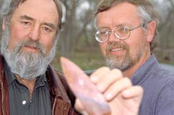 Dr. Dennis Stanford (left) and Dr. Bruce Bradley (right) examining a stone tool. 