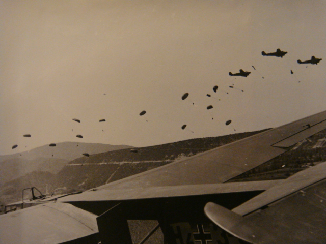 Another view of parachute drop with glider in the foreground.&nbsp;