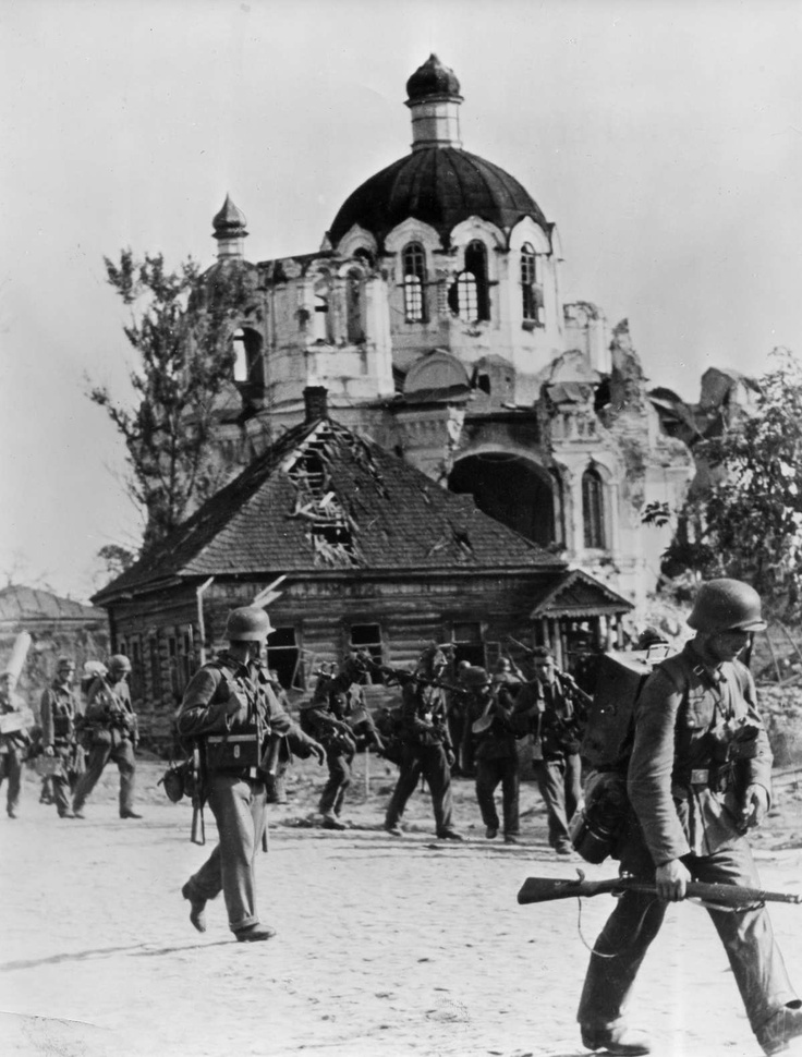German troops march past a church as they move deeper into Russia in 1941.