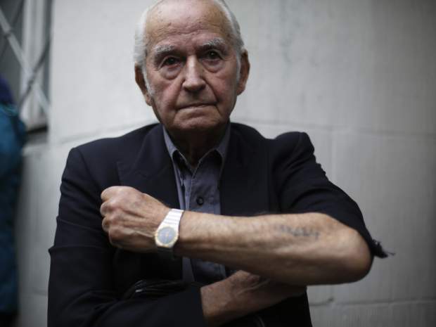 Leon Schwarzbaum shows what he says is his Auschwitz tattoo number in a 2015 file photo.