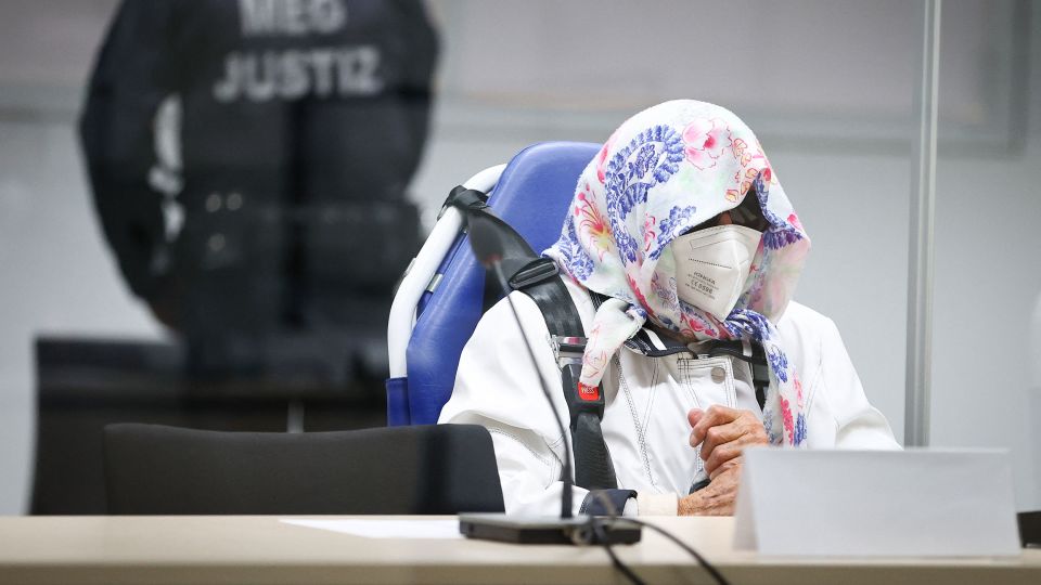 Irmgard Furchner sits well-covered in the courtroom in Itzehoe, Germany&nbsp; appearing to be 'holstered' to her seat.