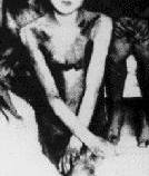 A detail of seated girl on far left which shows plainly that it’s a painting.