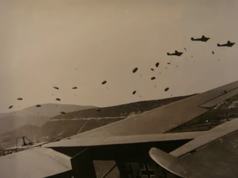 Another view of parachute drop with glider in the foreground.